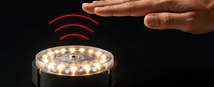 A hand hovering above the ReflexPod to trigger it using infrared proximity